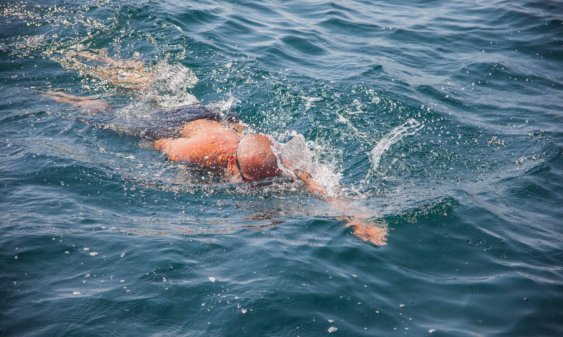 Open water swimmer in the sea off Cornwall