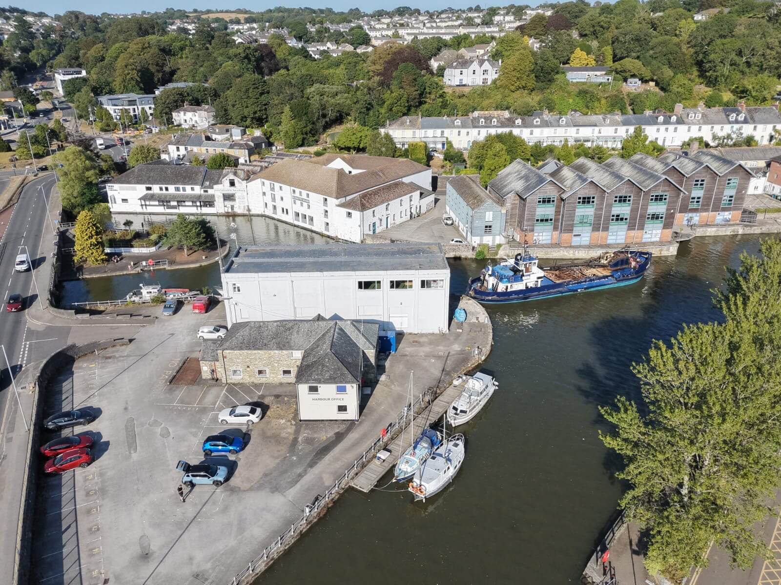 Truro harbour office, quayside car park and the Mannin on the river