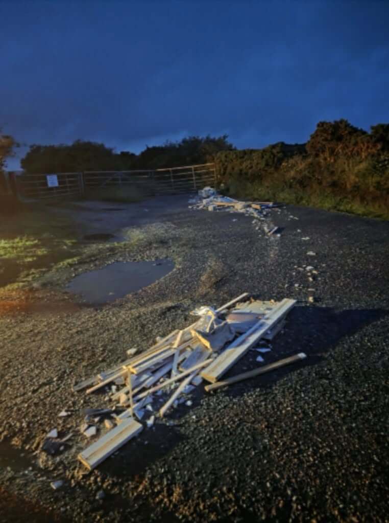 Dumped timber and rubble on the track at Belowda at dusk