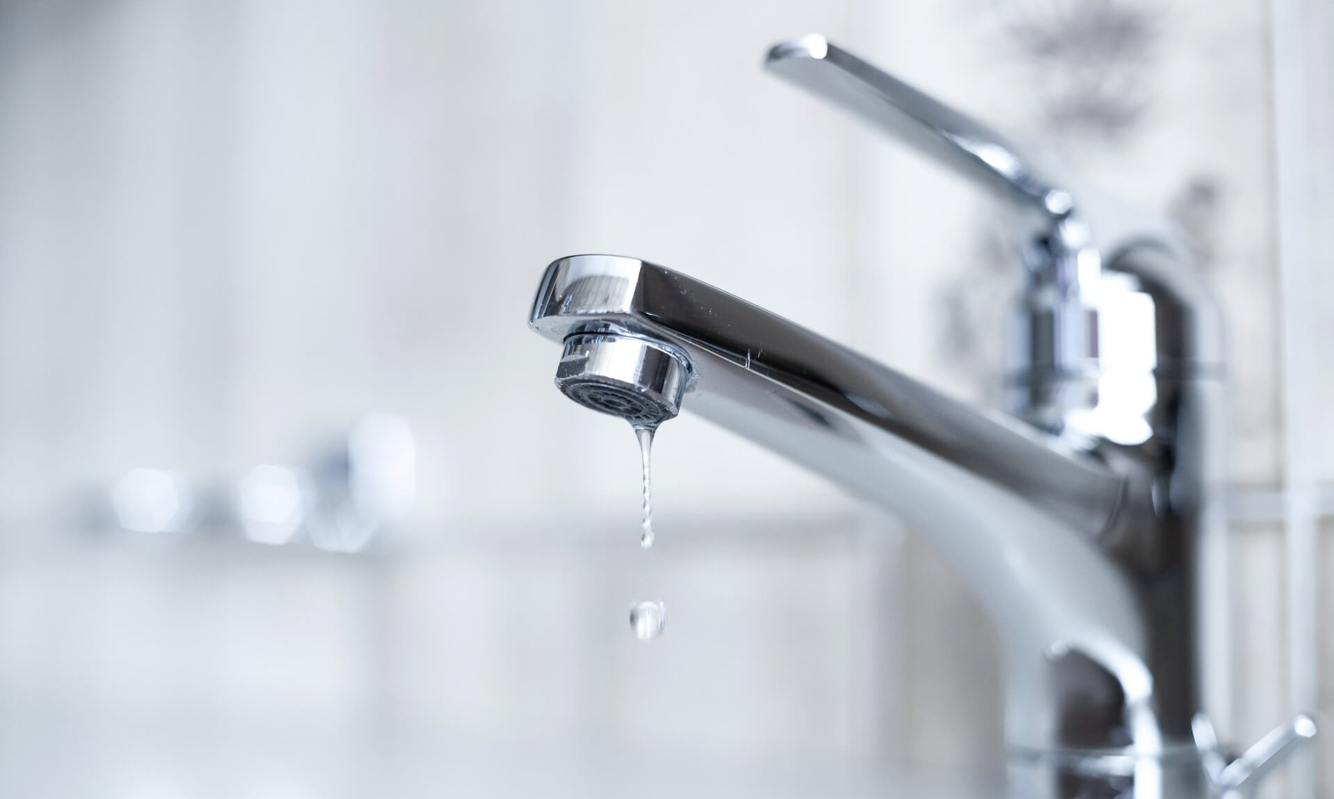 Water dripping from a chrome kitchen tap