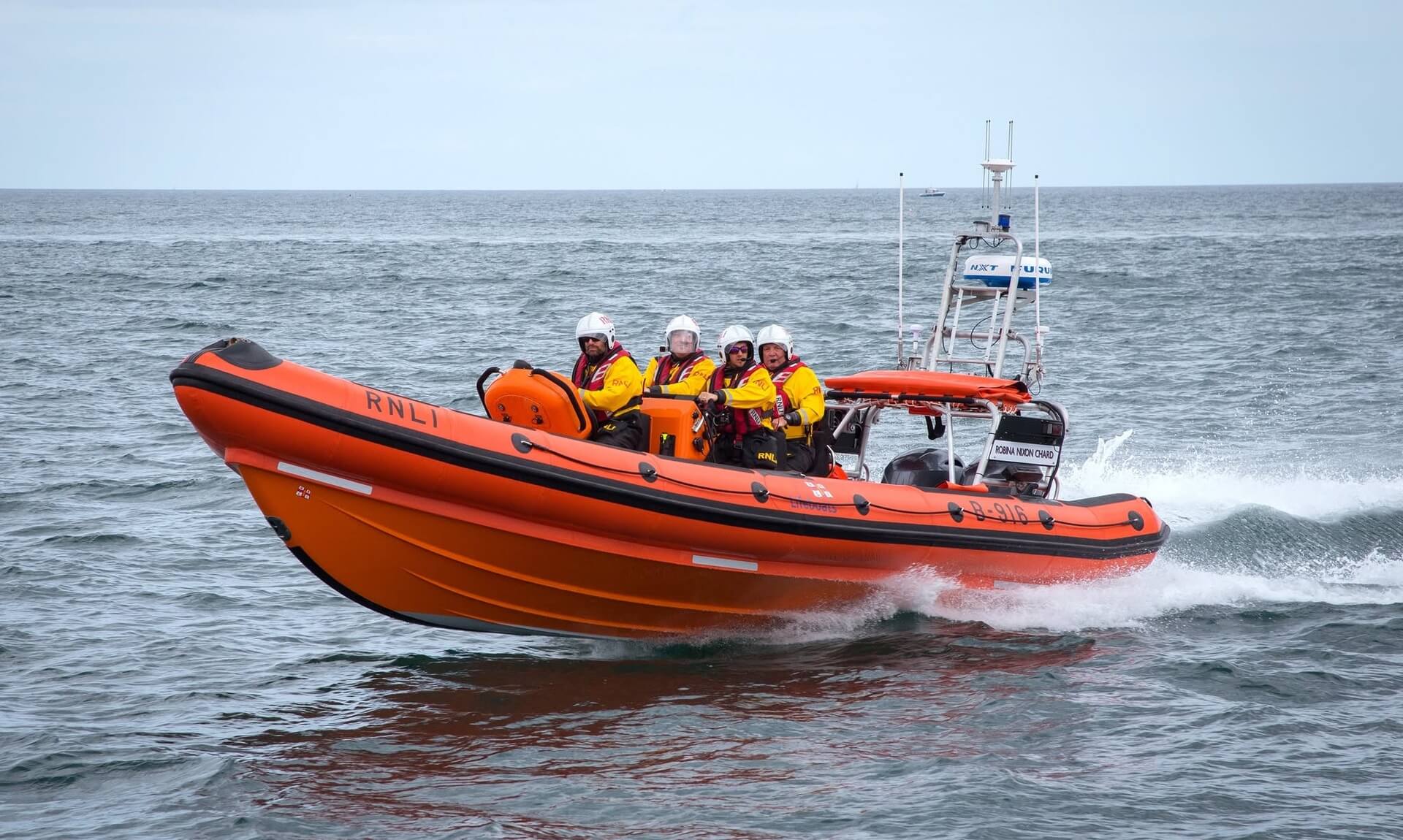 Falmouth RNLI B-class inshore lifeboat Robina Nixon Chard at speed with four crew aboard