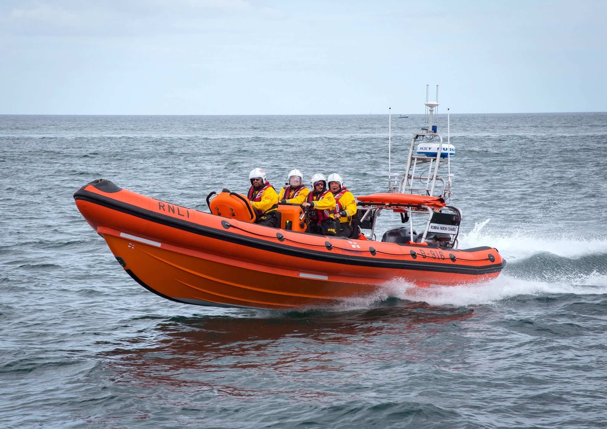 Falmouth RNLI B-class inshore lifeboat Robina Nixon Chard at speed with four crew aboard