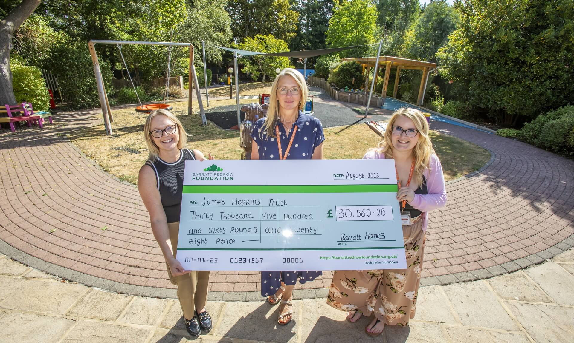 Barratt Bristol staff presenting a cheque for £30,560.28 to James Hopkins Trust at Kites Corner