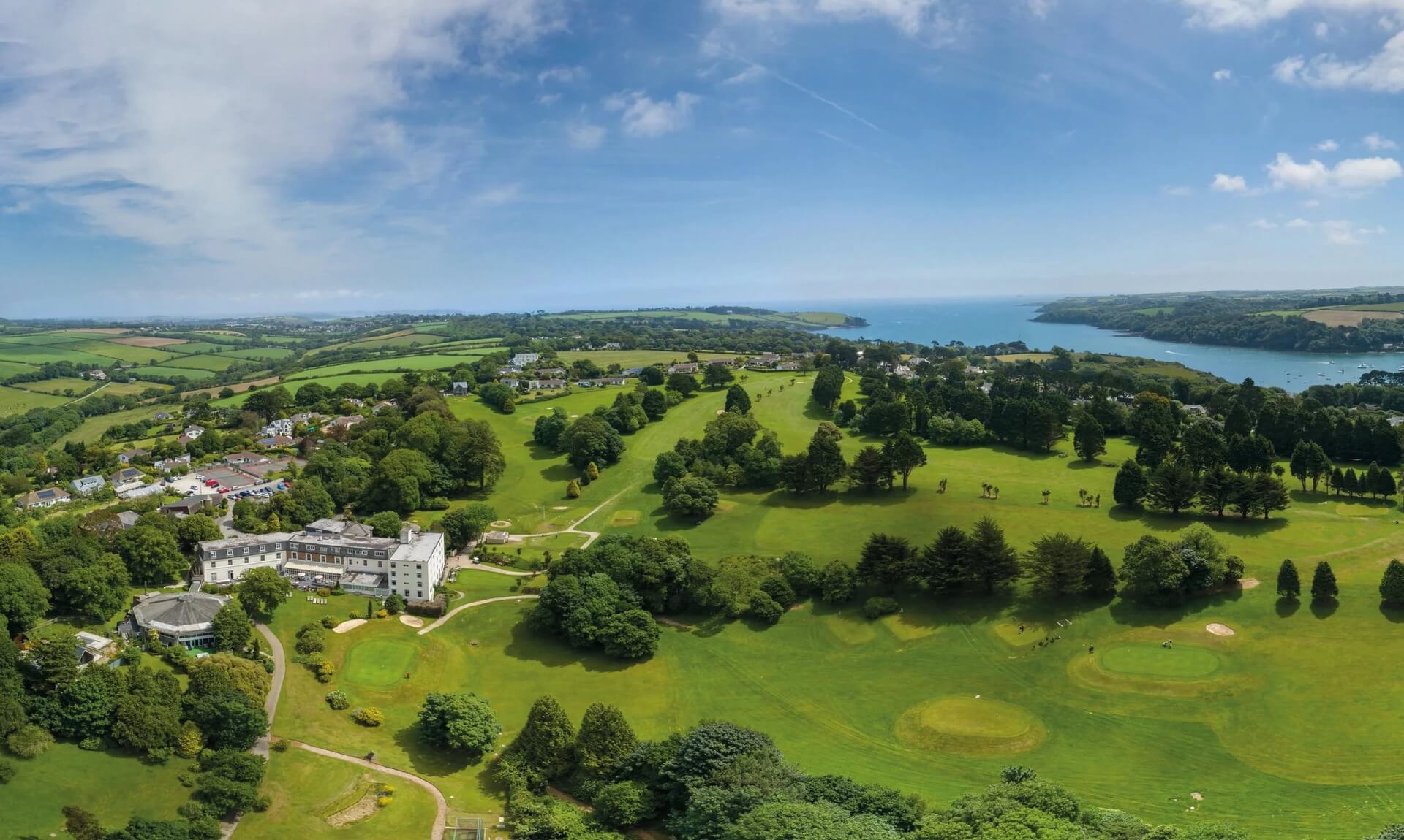 Aerial view of Budock Vean Hotel, its golf course and the Helford River