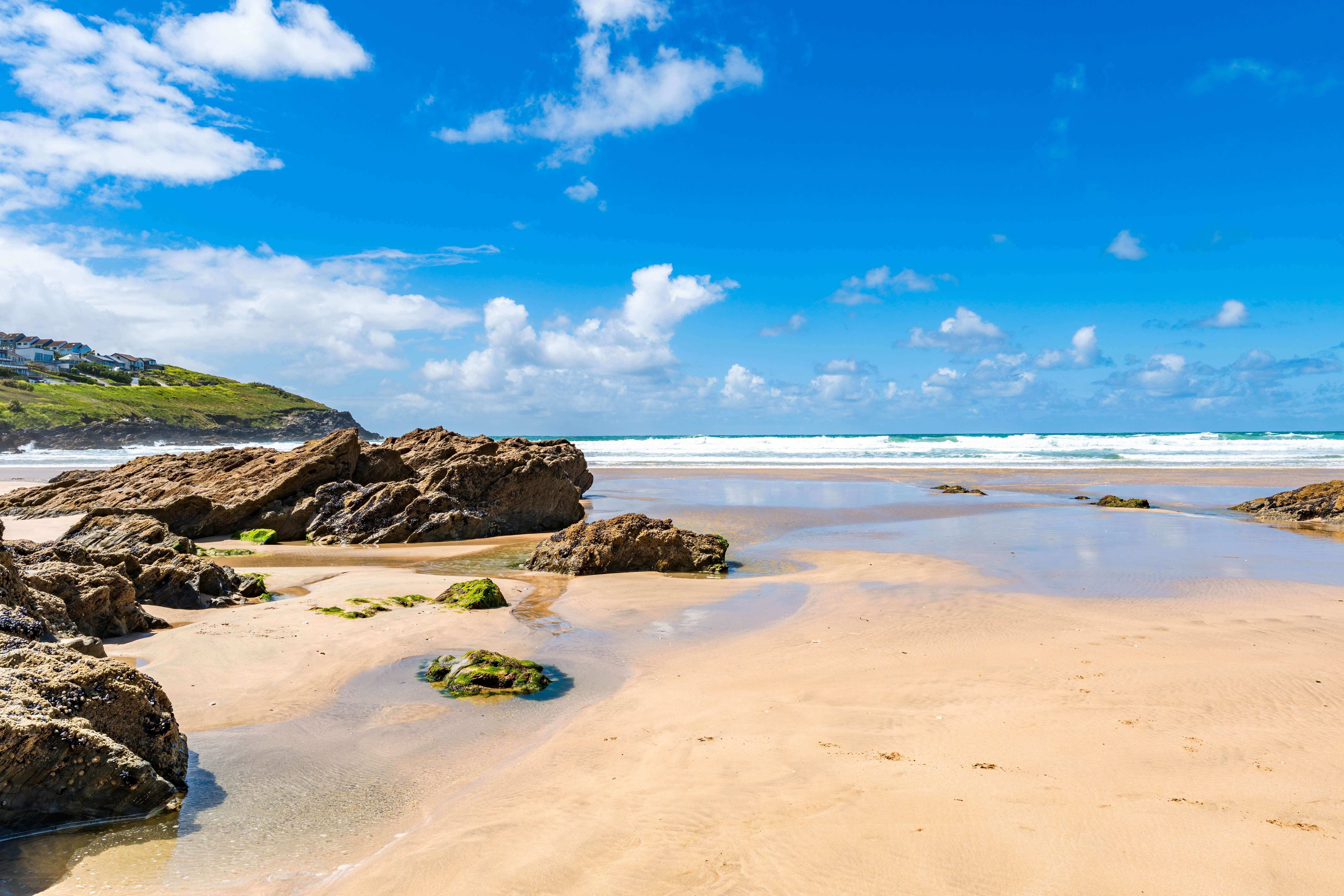 Fistral beach in Newquay at low tide under a blue sky