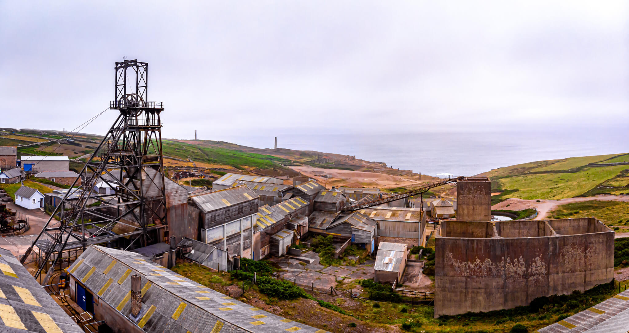 Geevor Tin Mine, the Victory Shaft headframe above the dressing-floor sheds with the coast behind