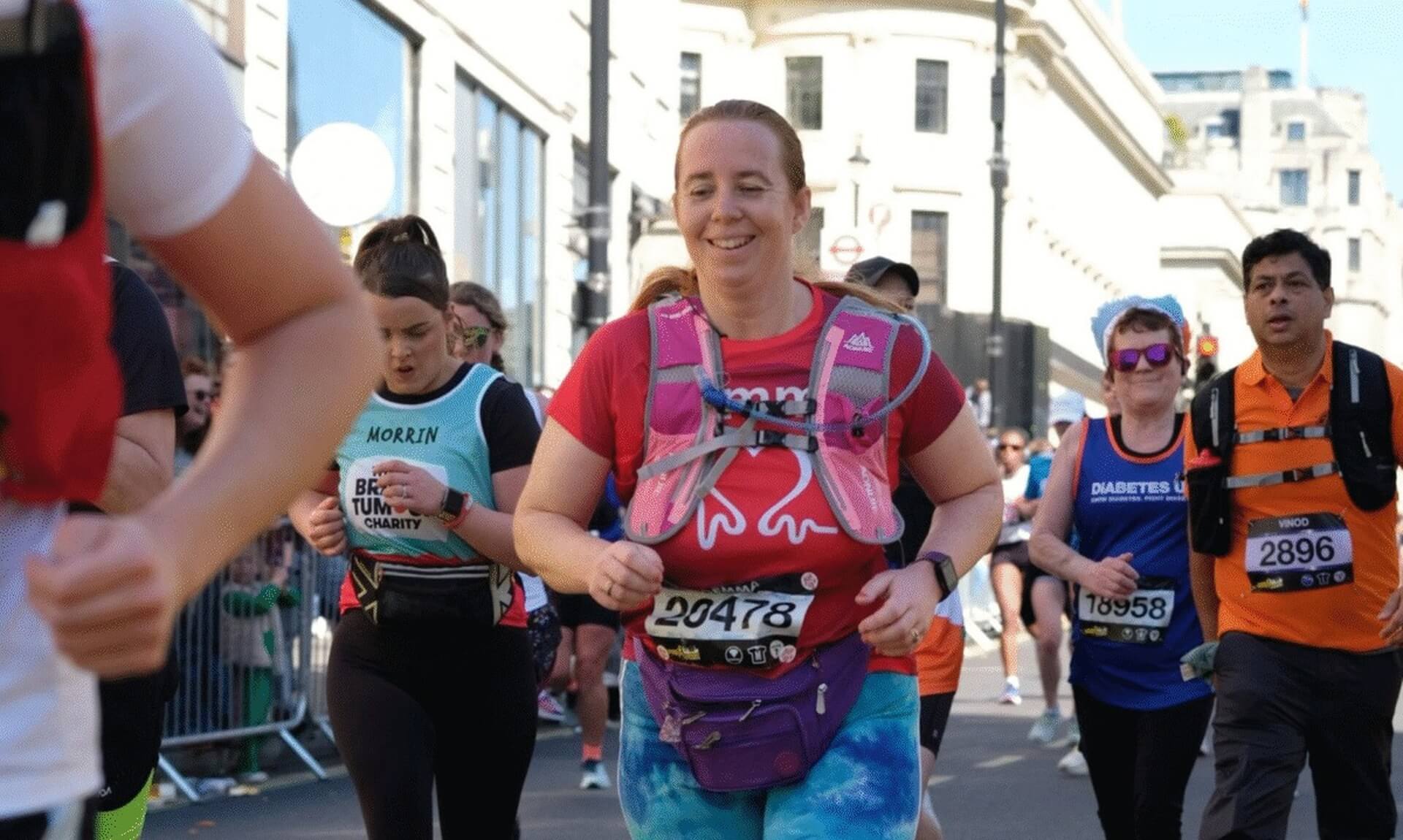 Gemma Wotherspoon running the London Marathon in a red top and pink hydration vest