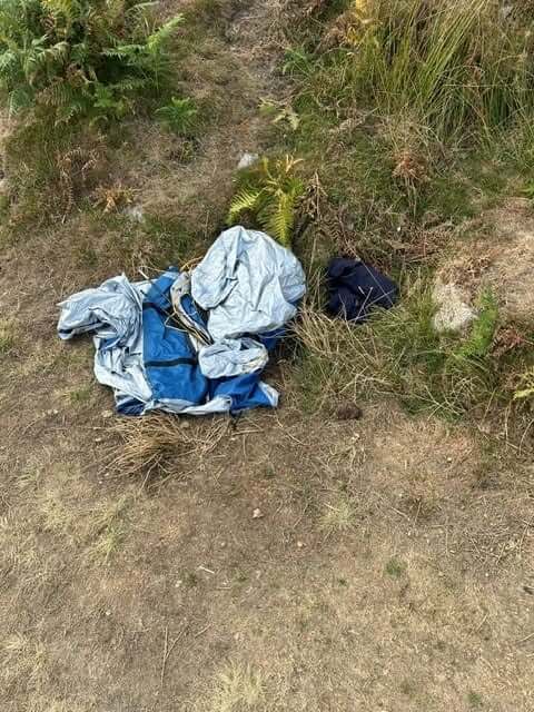 A broken tent and tarpaulin abandoned in the bracken near Minions