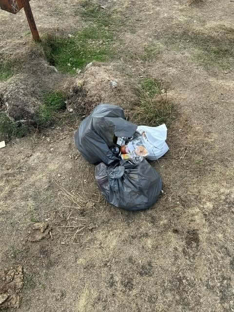 Black bin bags of rubbish left on the ground at Golddiggings on Bodmin Moor