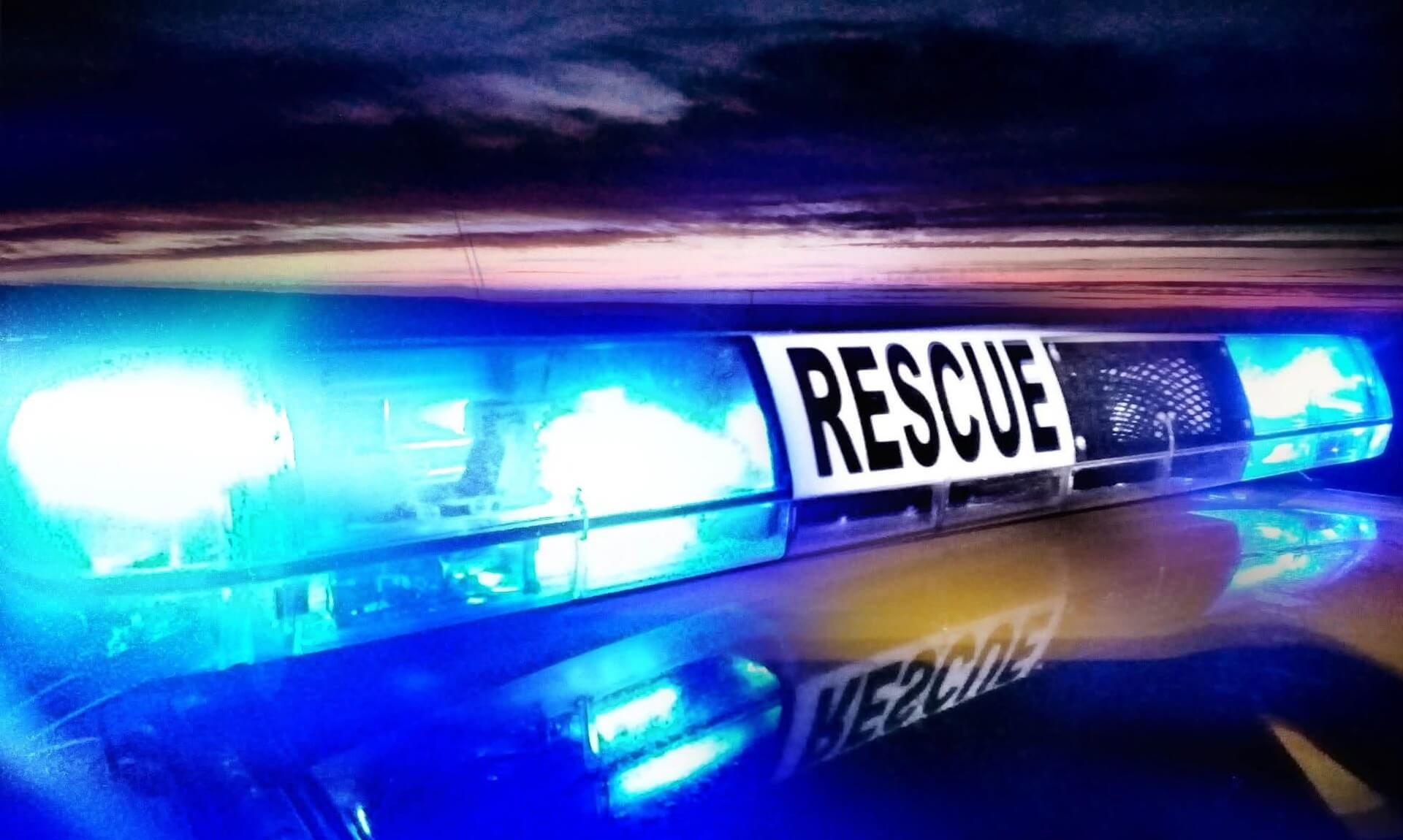 Blue rescue lights on a coastguard vehicle at night