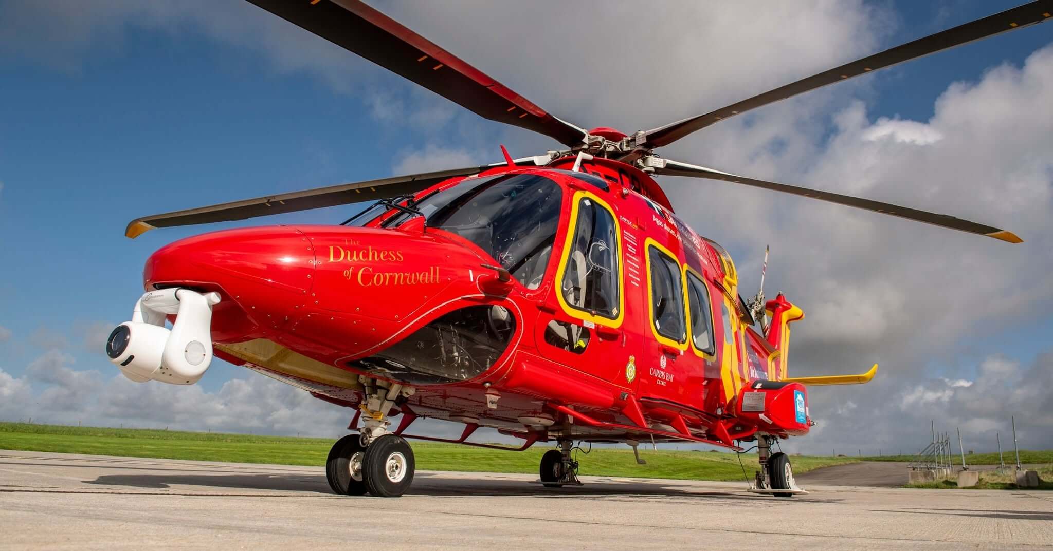 Cornwall Air Ambulance helicopter, the Duchess of Cornwall, parked with rotors overhead