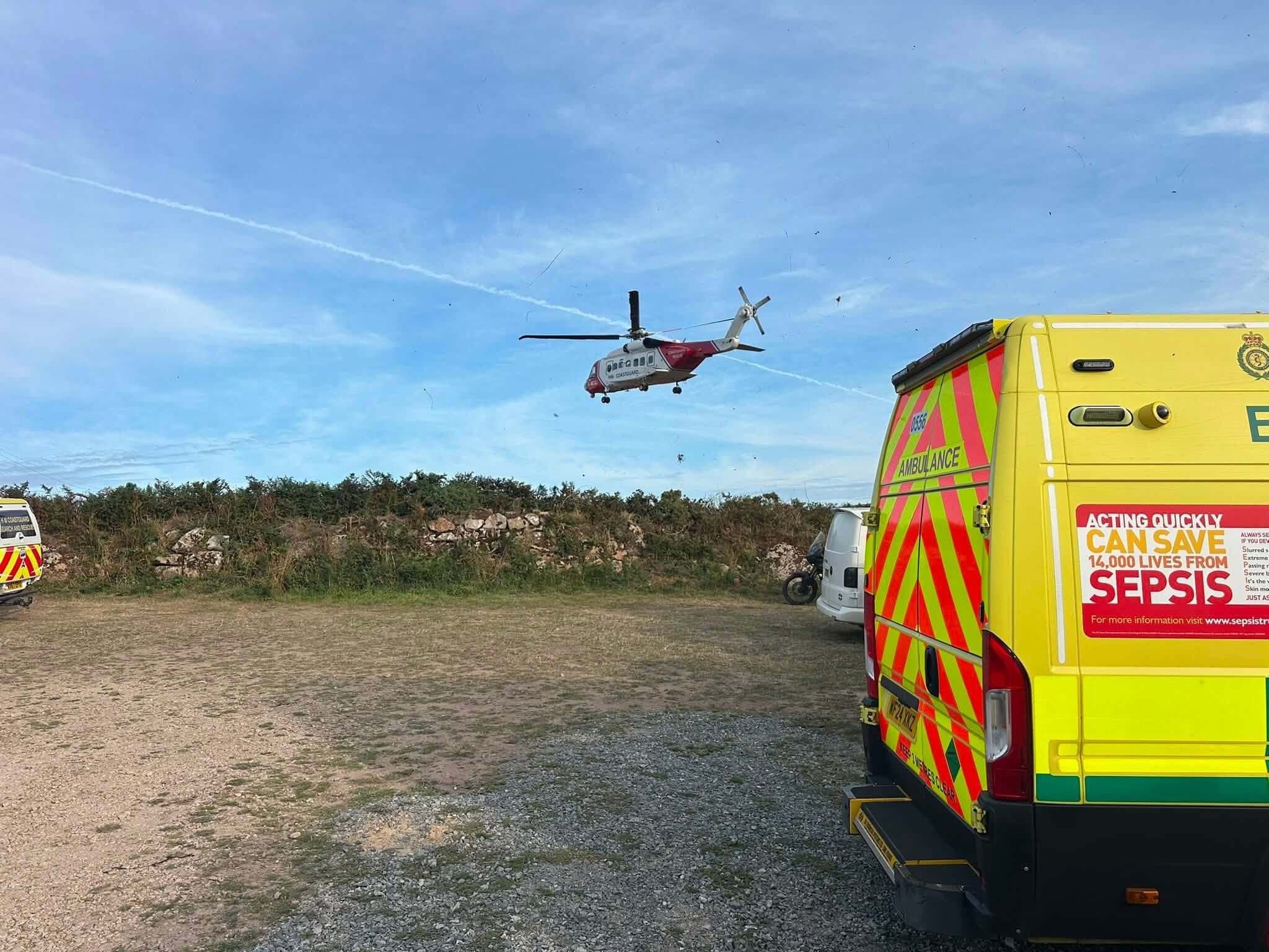 Coastguard helicopter approaching over an ambulance at Portheras Cove