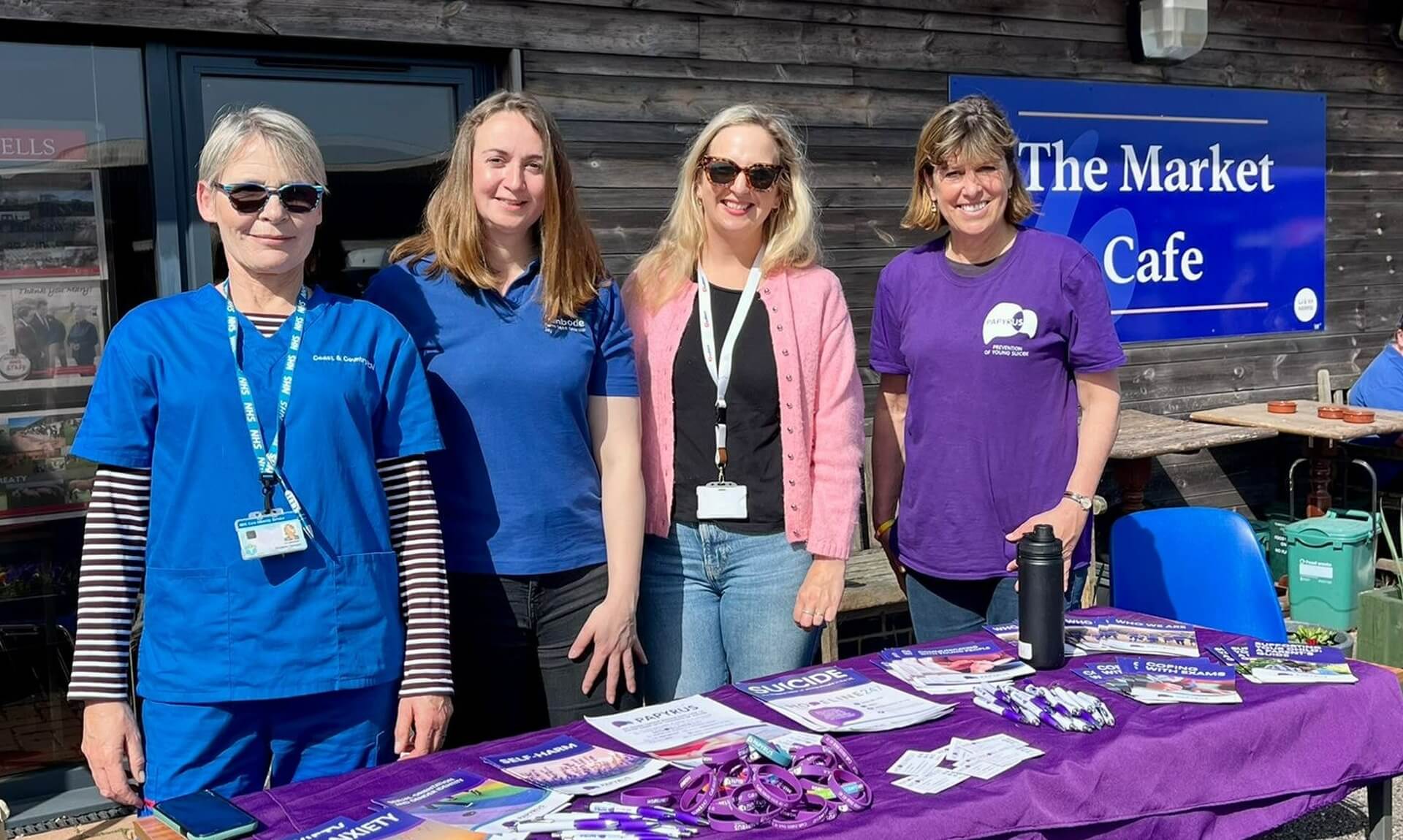 Four members of the Market Health Hub team at a stall outside The Market Cafe at Holsworthy livestock market