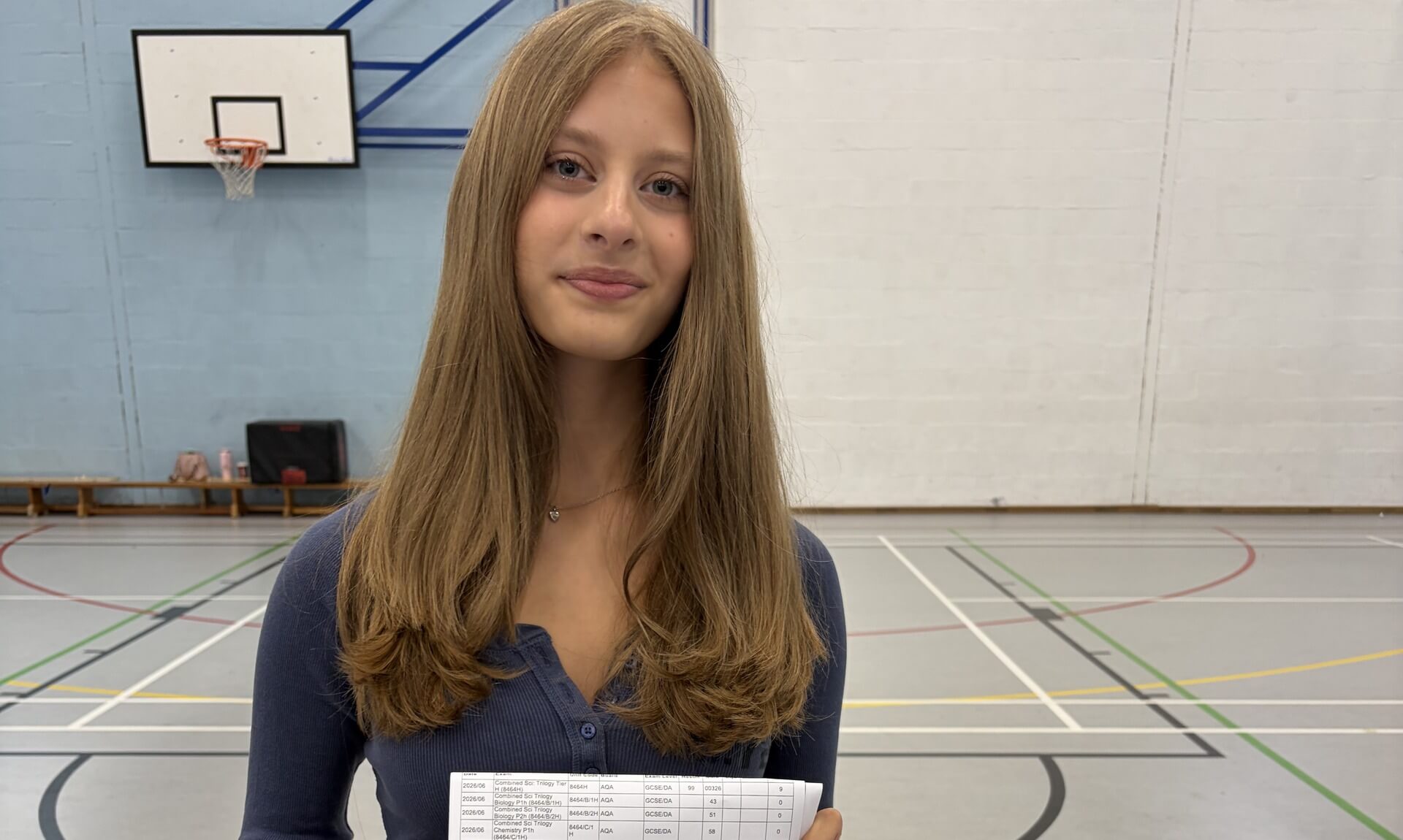 Launceston College student smiling while holding her GCSE results
