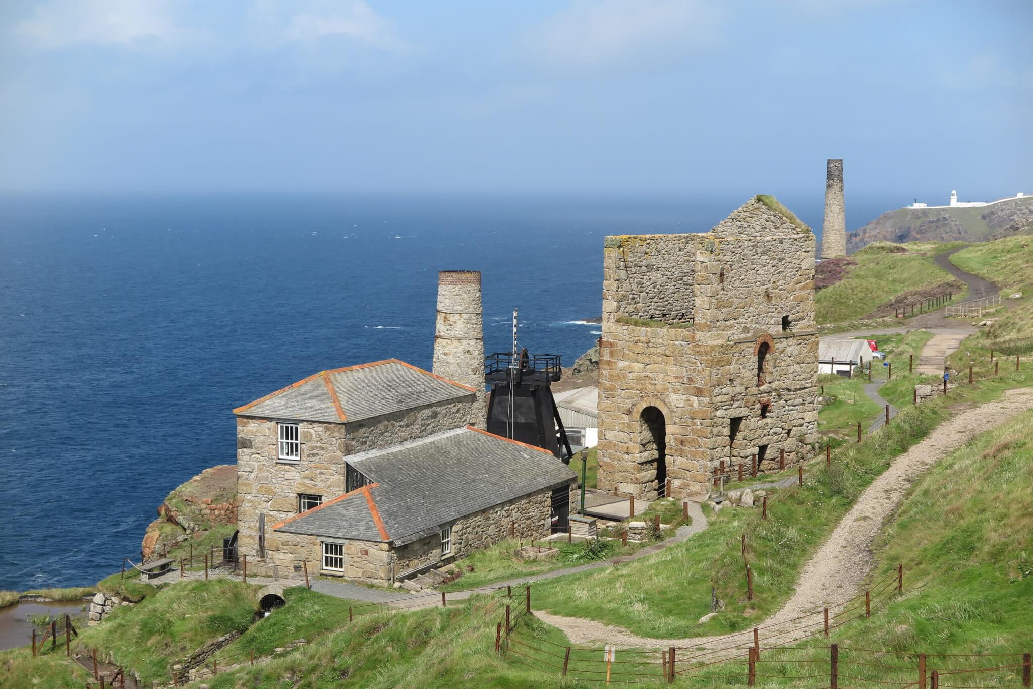 Levant Mine engine house and chimney on the cliff above a blue sea near Pendeen