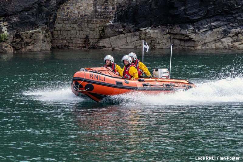 Looe RNLI D Class inshore lifeboat crew on the river at speed