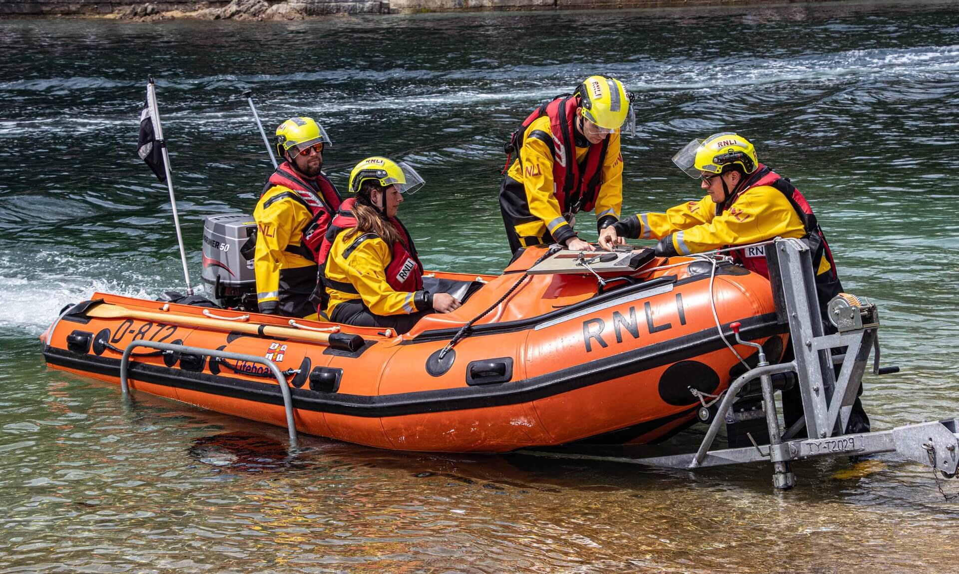 Looe RNLI D Class lifeboat Ollie Naismith II with crew on the water