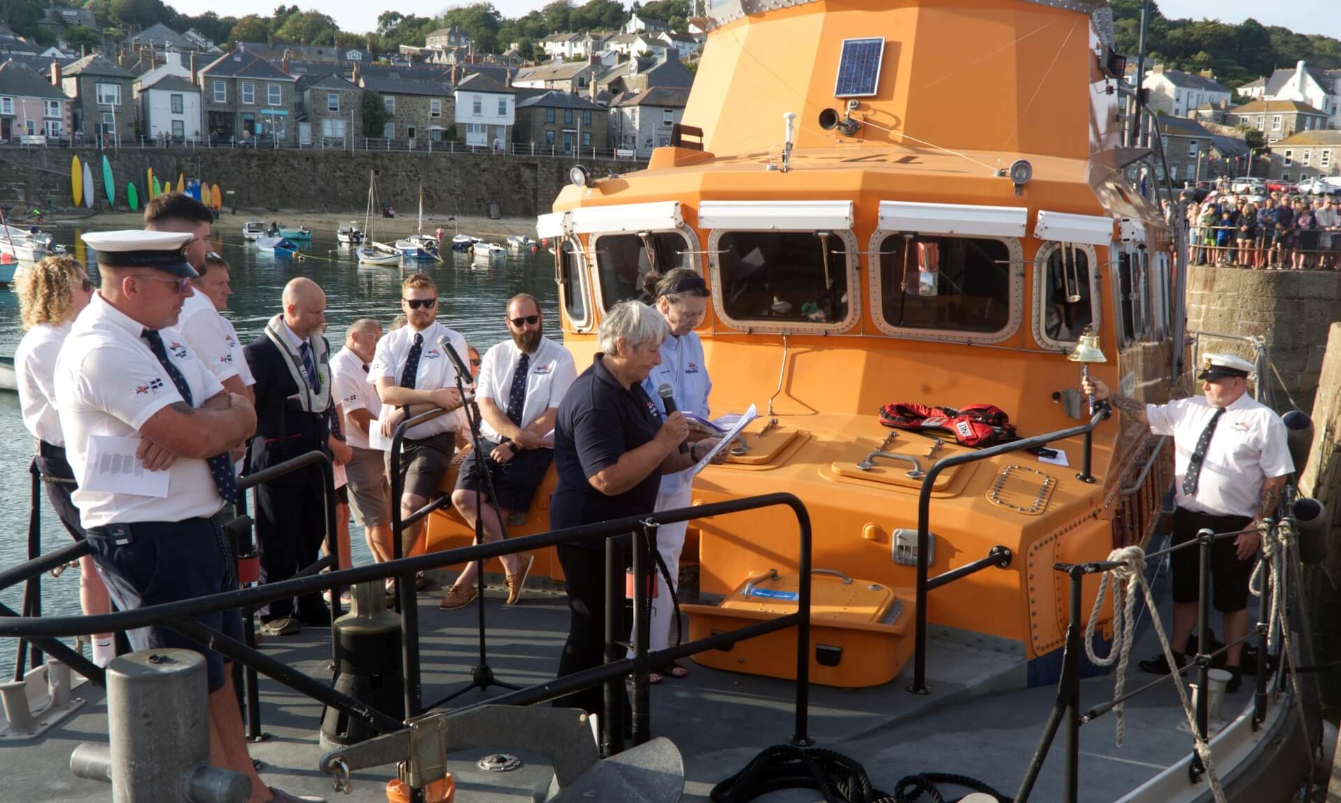 Crowd and Penlee lifeboat crew gathered for the blessing service at Mousehole harbour