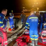 HM Coastguard search and rescue team members with their kit during a night callout in Newquay