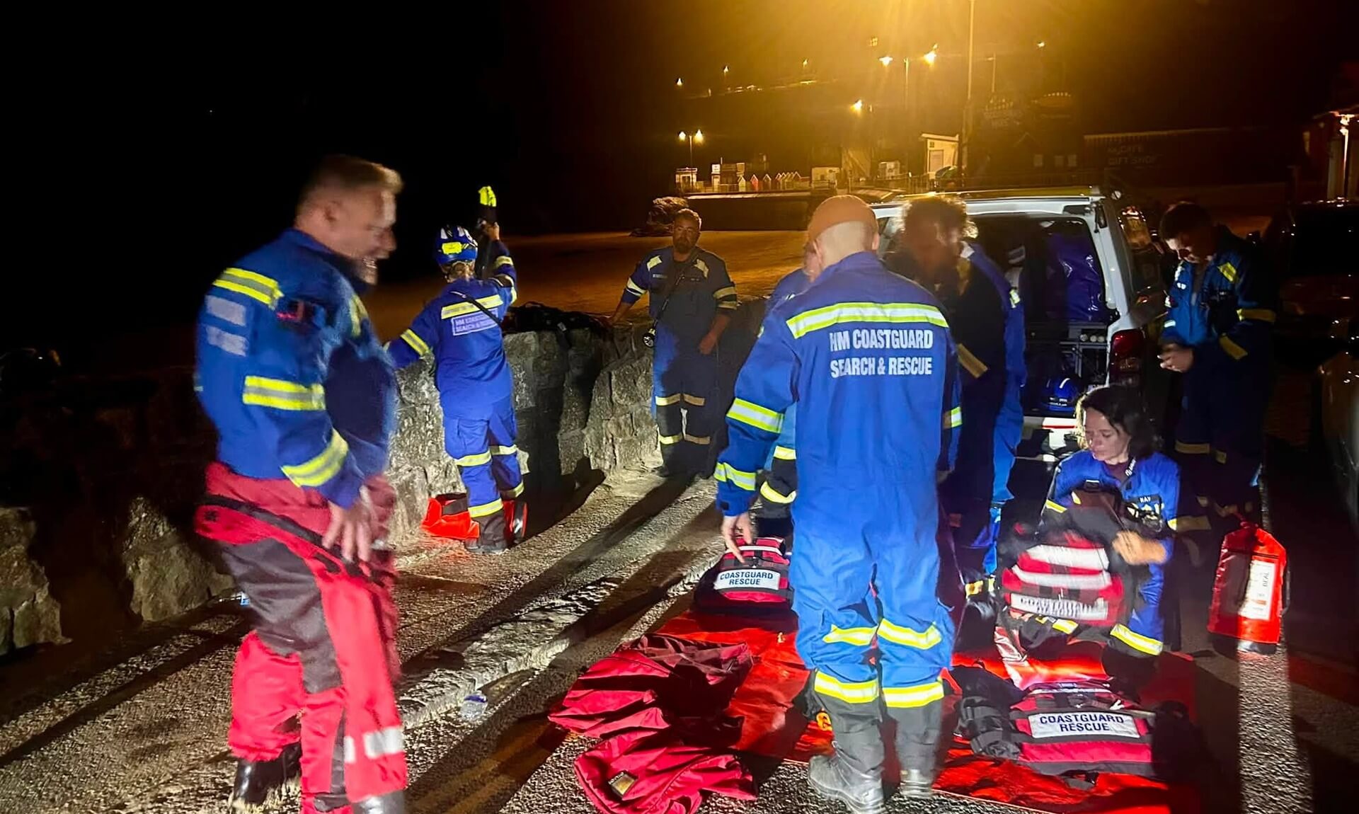 HM Coastguard search and rescue team members with their kit during a night callout in Newquay