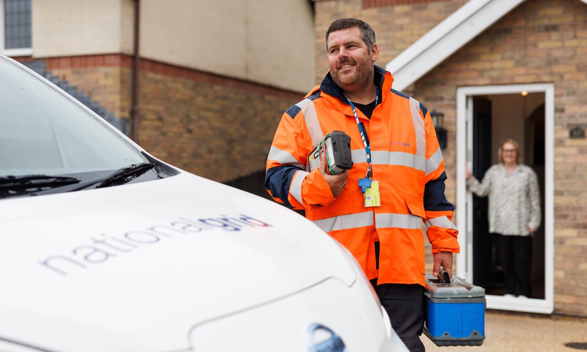 NGED inspector arriving at a property with a National Grid van