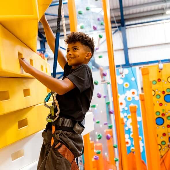 Child climbing one of the walls at NQY Rocks