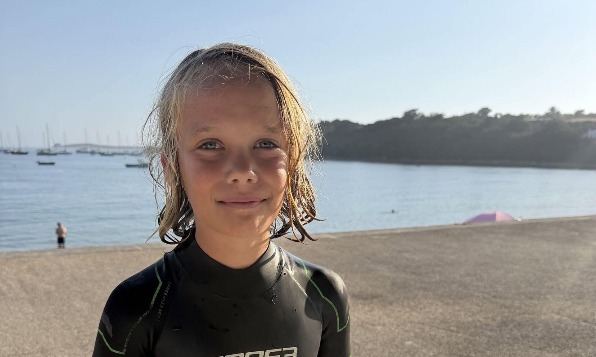 Orkney, an 11-year-old from the Isles of Scilly, in a wetsuit beside the water