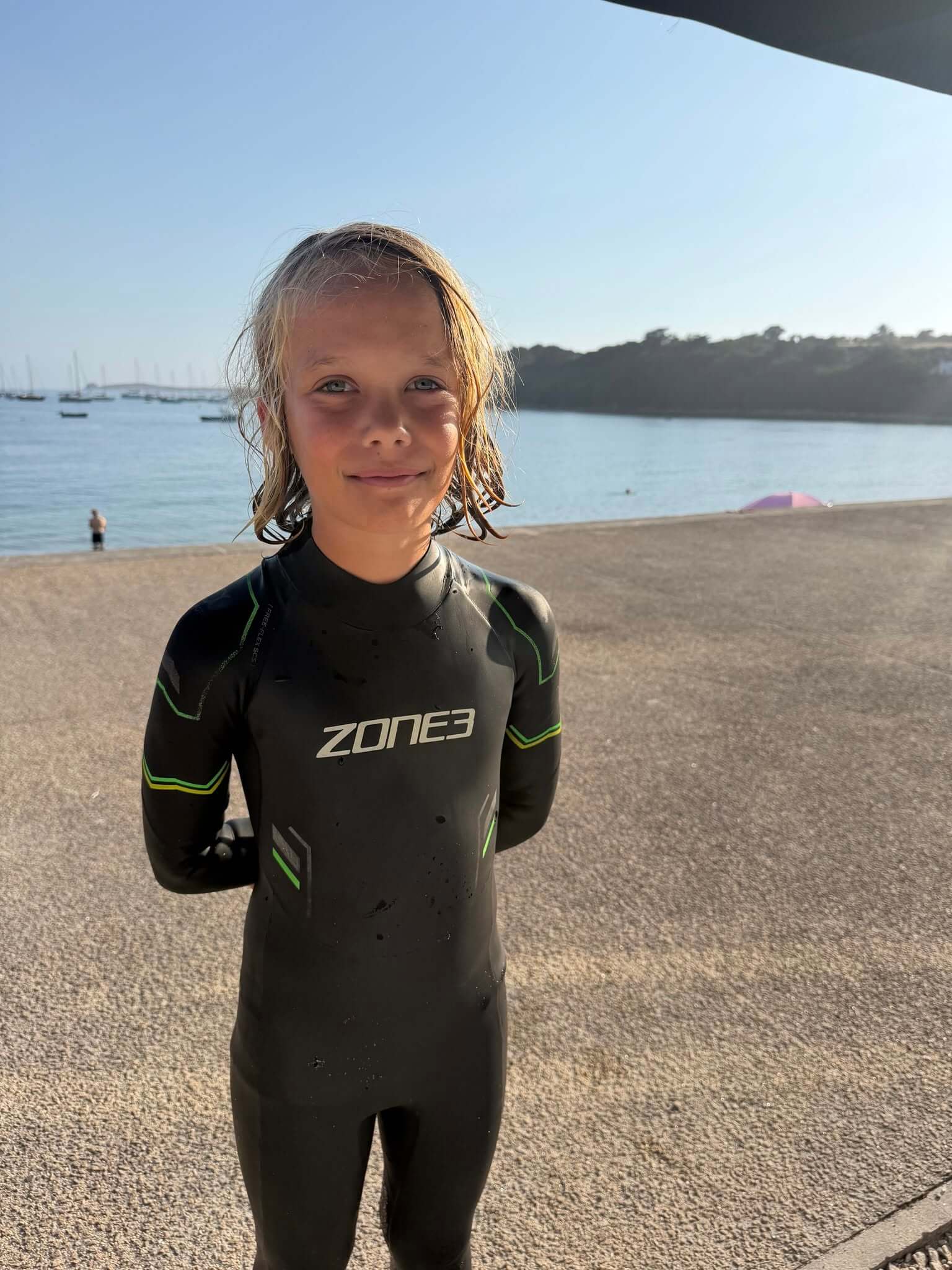 Orkney, an 11-year-old from the Isles of Scilly, in a wetsuit beside the water