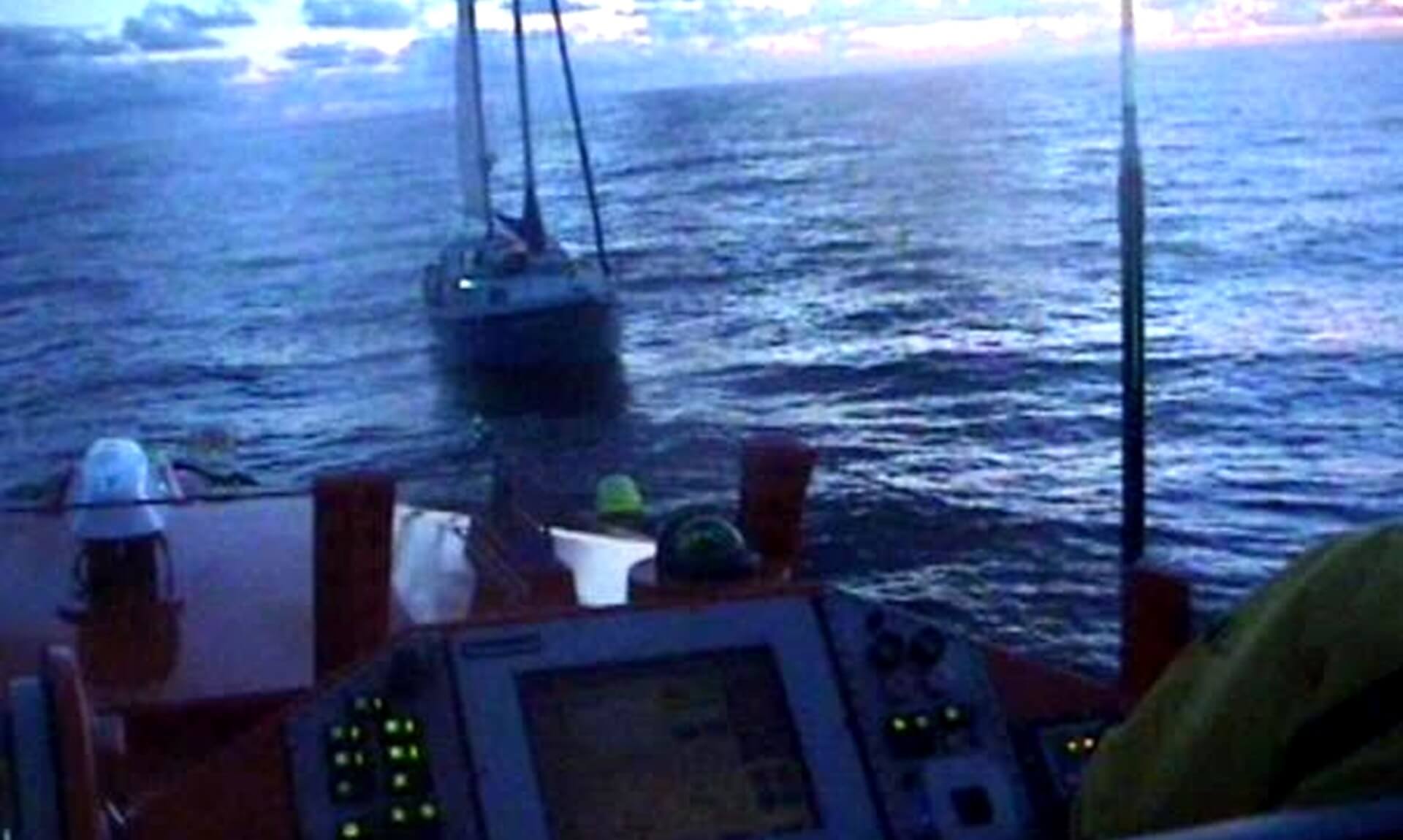 A yacht at dusk seen from the helm of Padstow RNLI's lifeboat after a fouled propeller off Bude