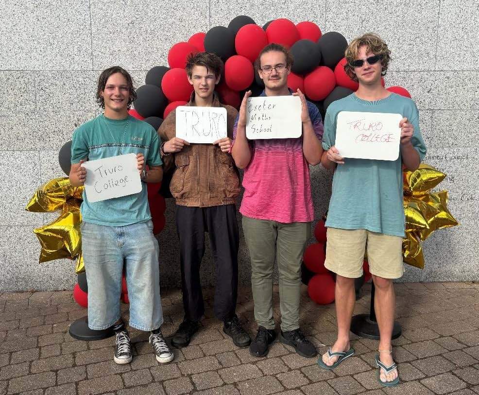 Penryn College students holding signs showing their next college destinations