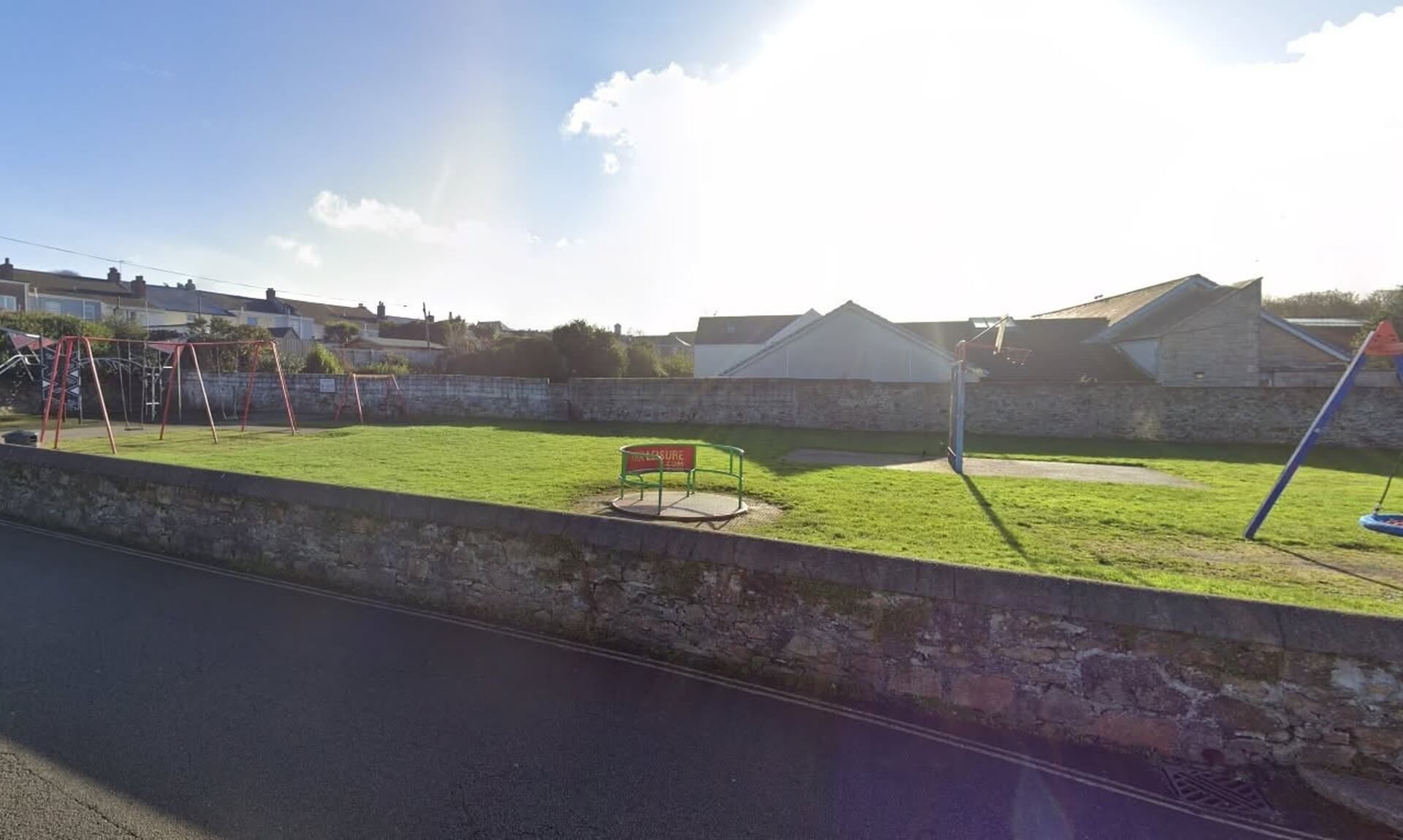 The play area at Plain-an-Gwarry Park in Redruth, with the green roundabout in the middle of the grass
