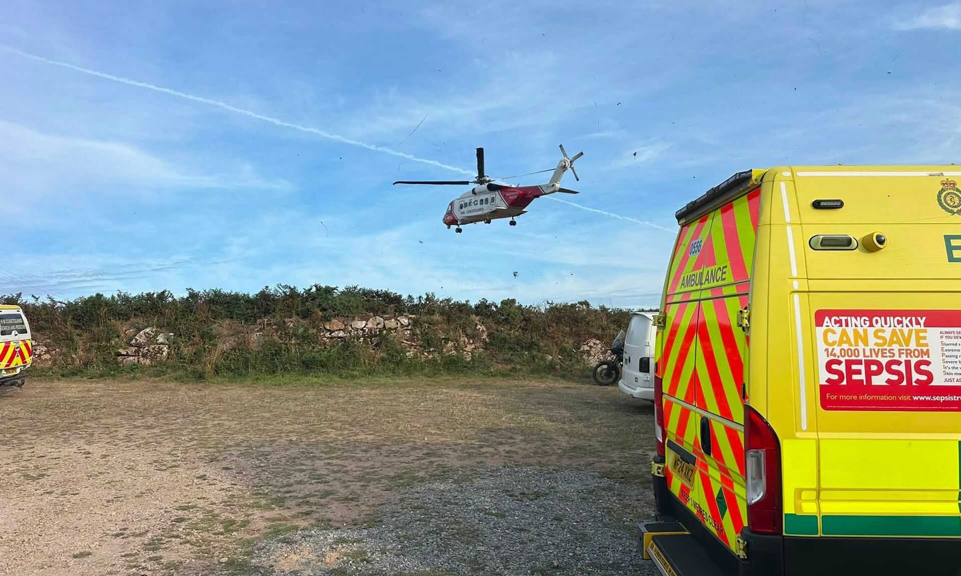 Coastguard helicopter approaching over an ambulance at Portheras Cove