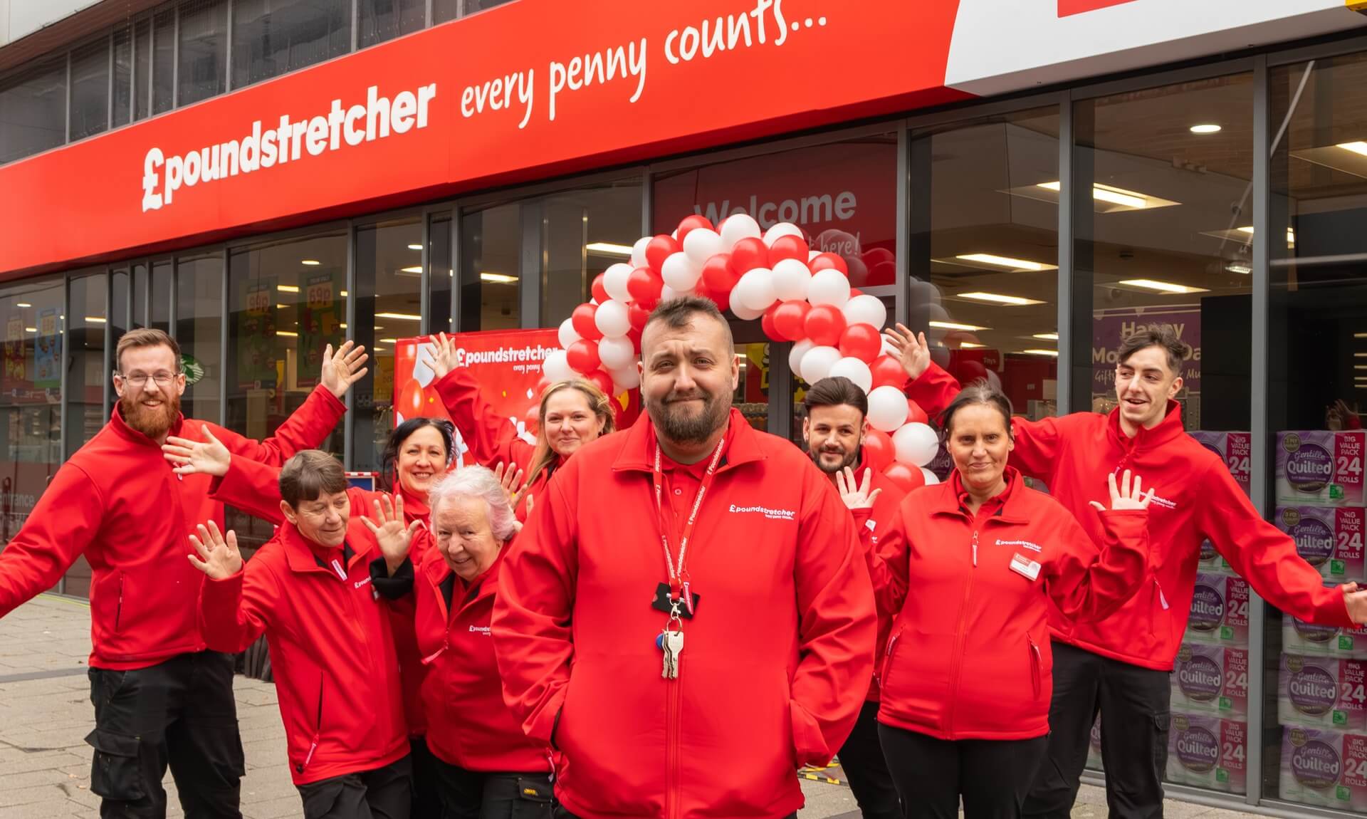 Poundstretcher staff celebrating a store opening with red and white balloons