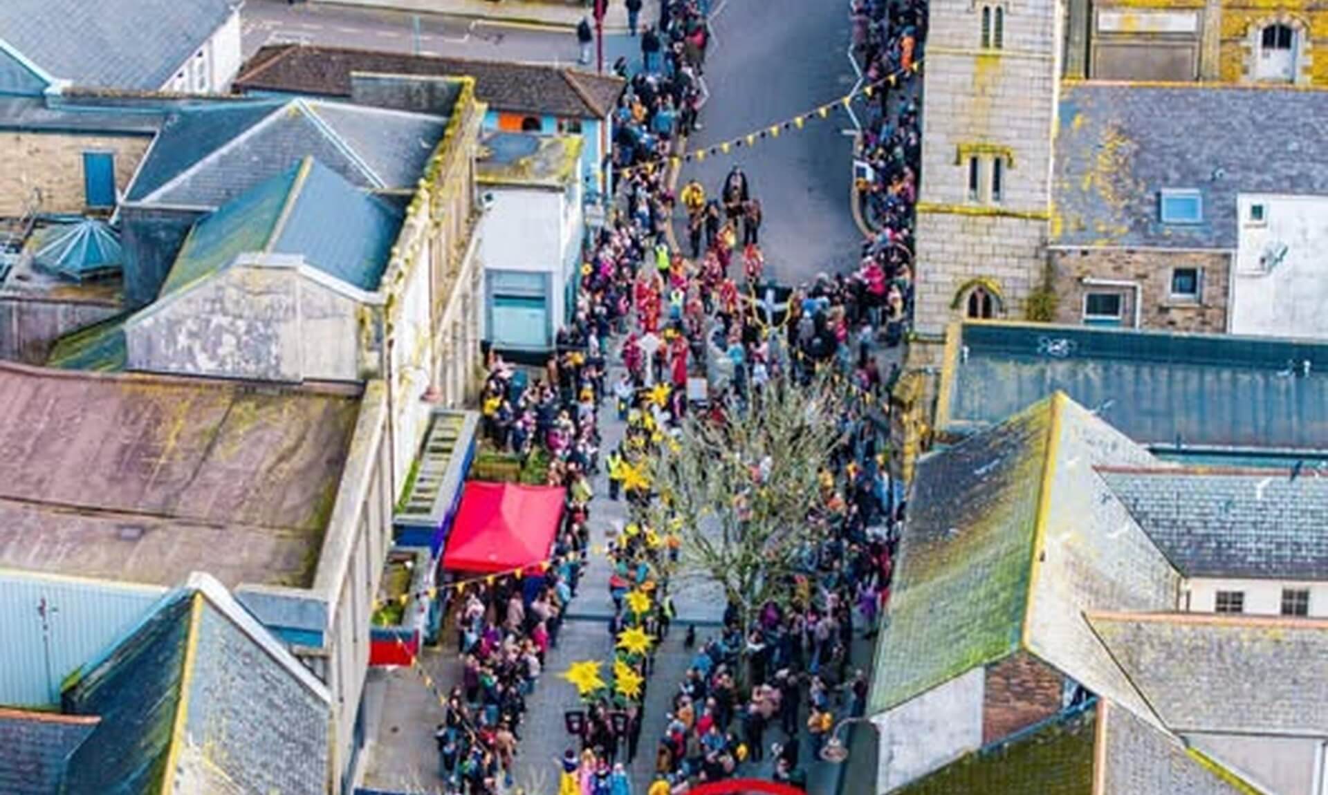Aerial view of a crowd filling Redruth town centre for a spring event
