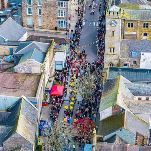 Aerial view of a crowd filling Redruth town centre for a spring event