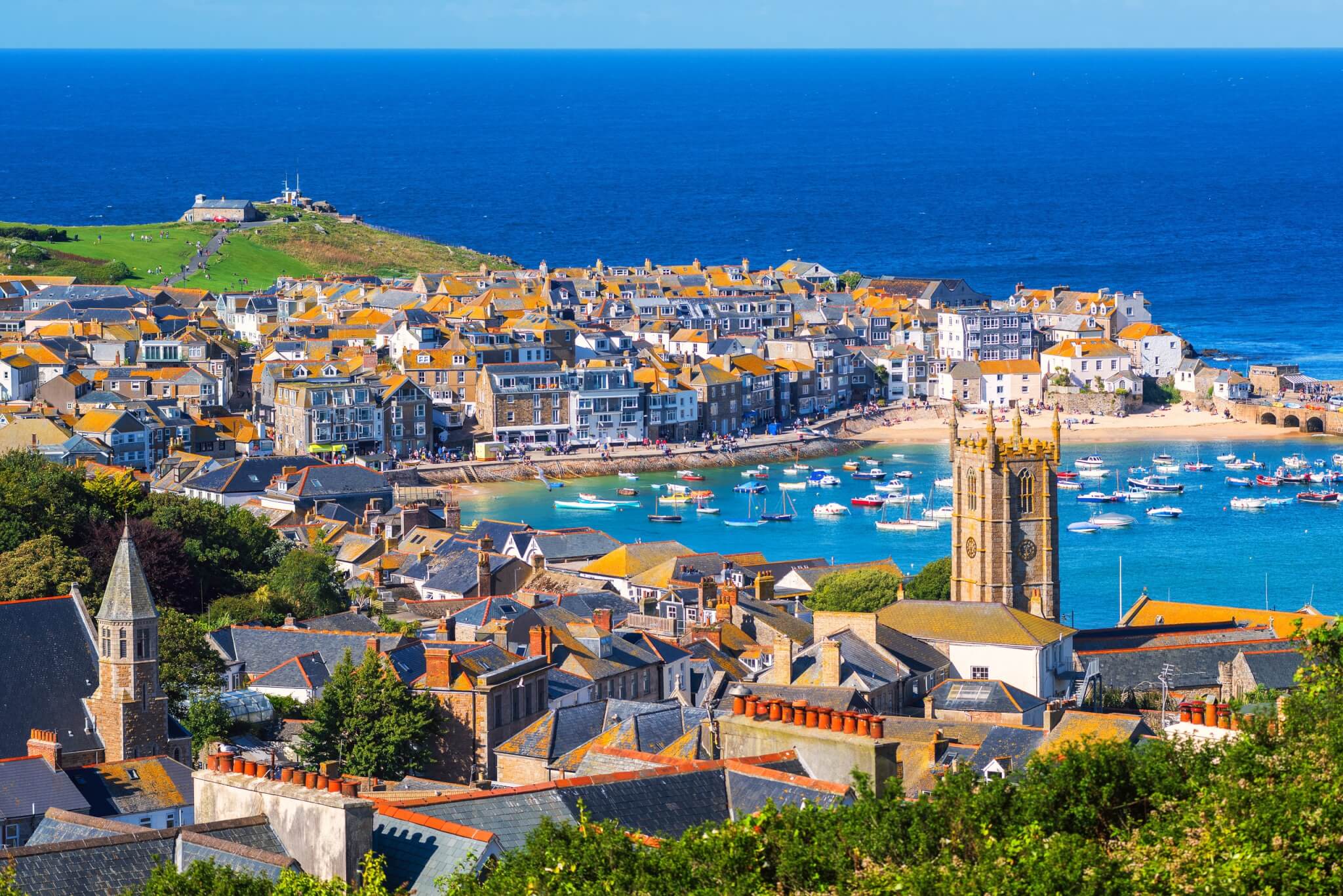 St Ives rooftops, church tower and harbour above St Ives Bay