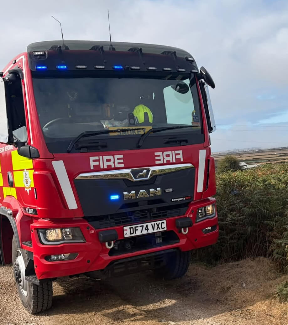 St Just fire engine parked on a rough track near Chapel Carn Brea with fields behind