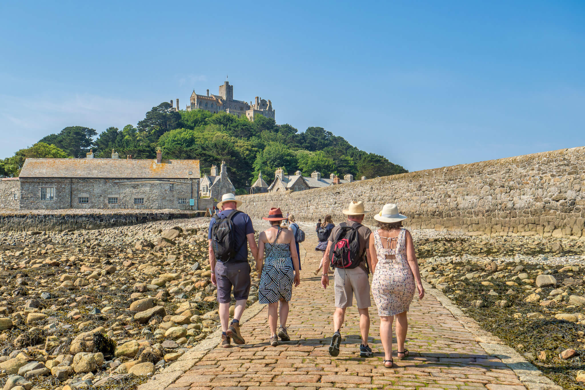 Visitors walking the cobbled causeway to St Michael's Mount at low tide