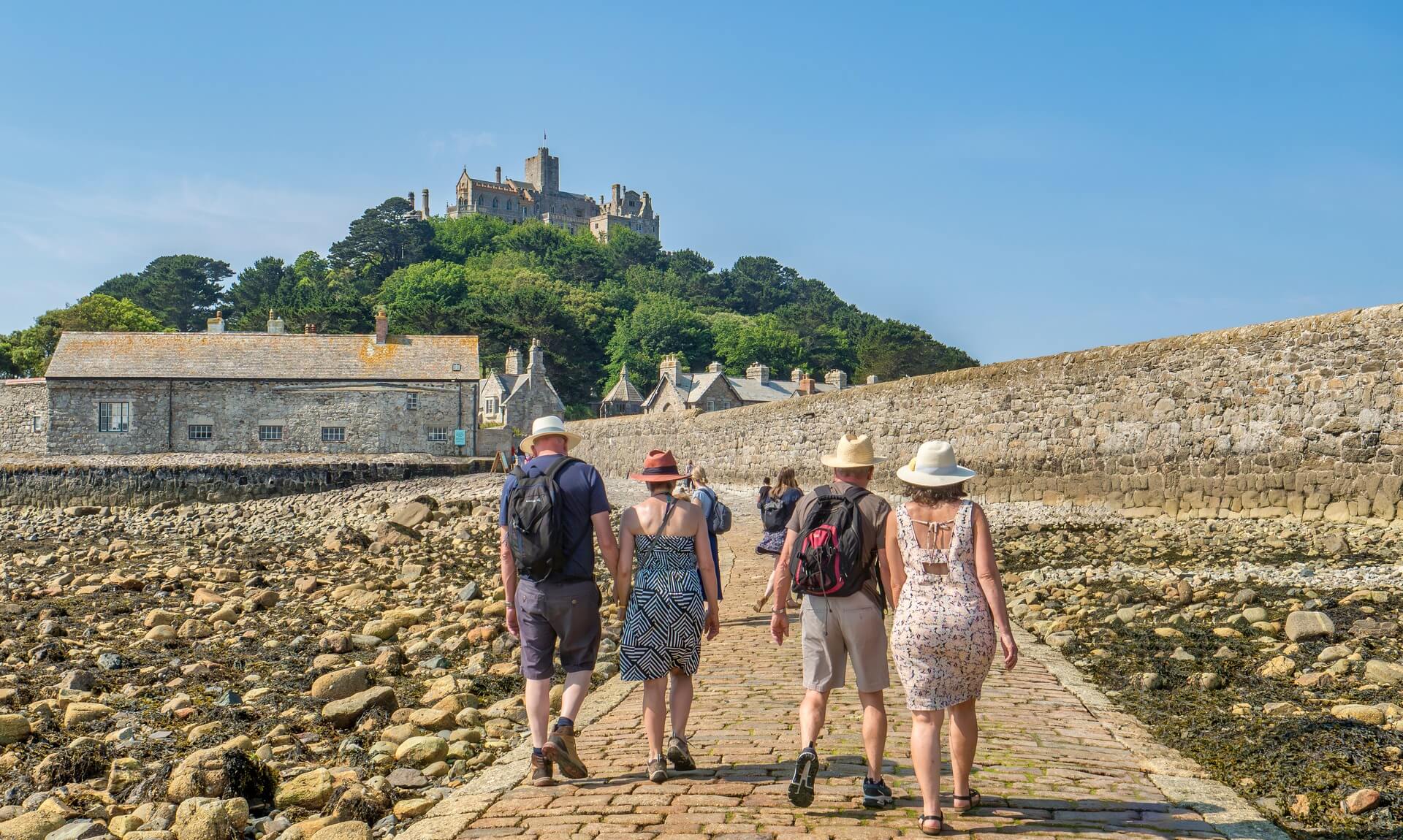 Visitors walking the tidal causeway to St Michael's Mount at low tide