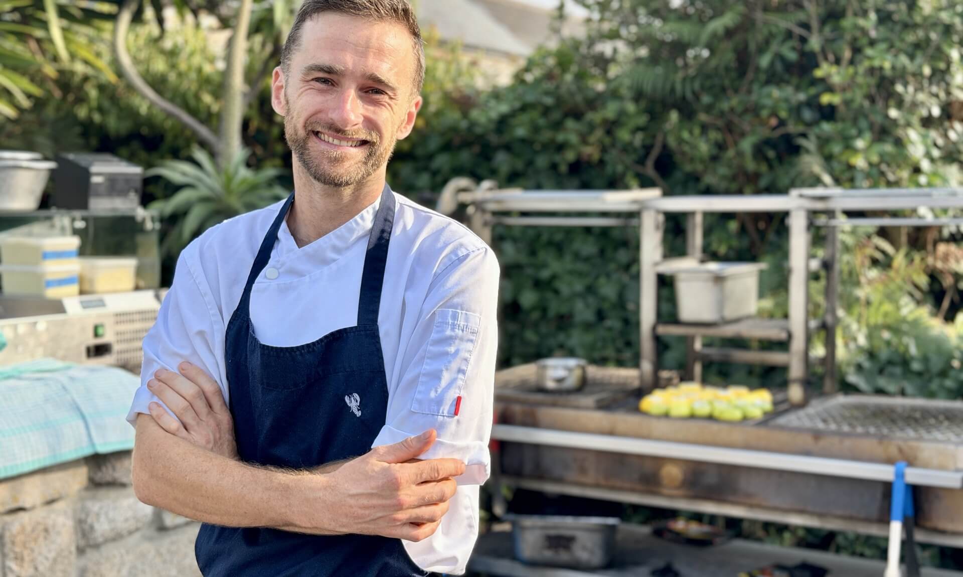 Tresco chef Matt Smith smiling with arms crossed