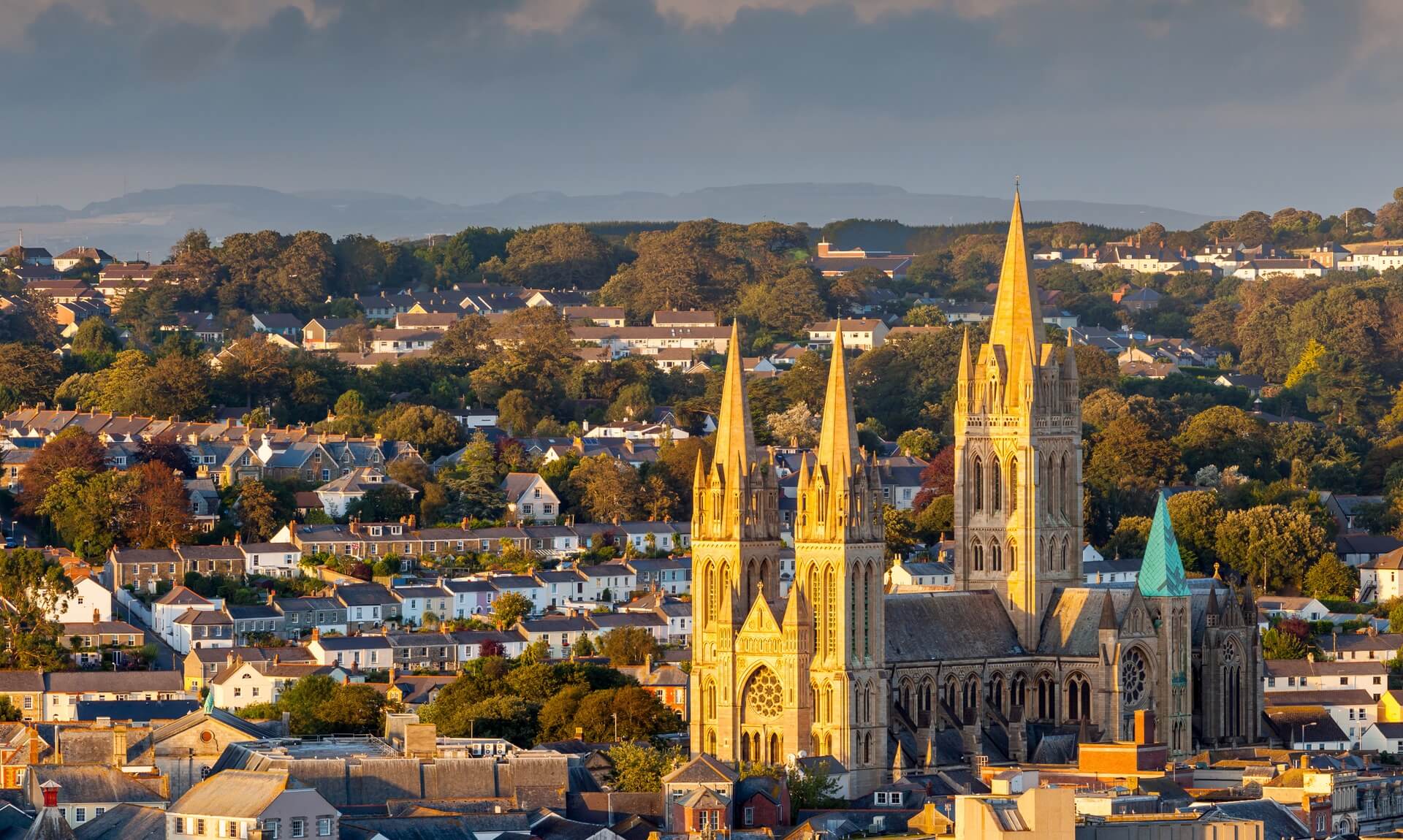 Truro Cathedral rising above the city rooftops in golden evening light