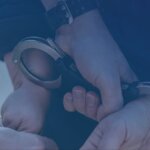 Hands in police handcuffs behind a person's back