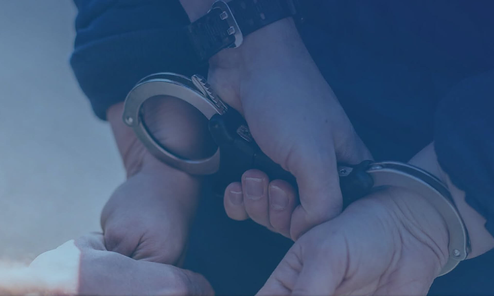 Hands in police handcuffs behind a person's back