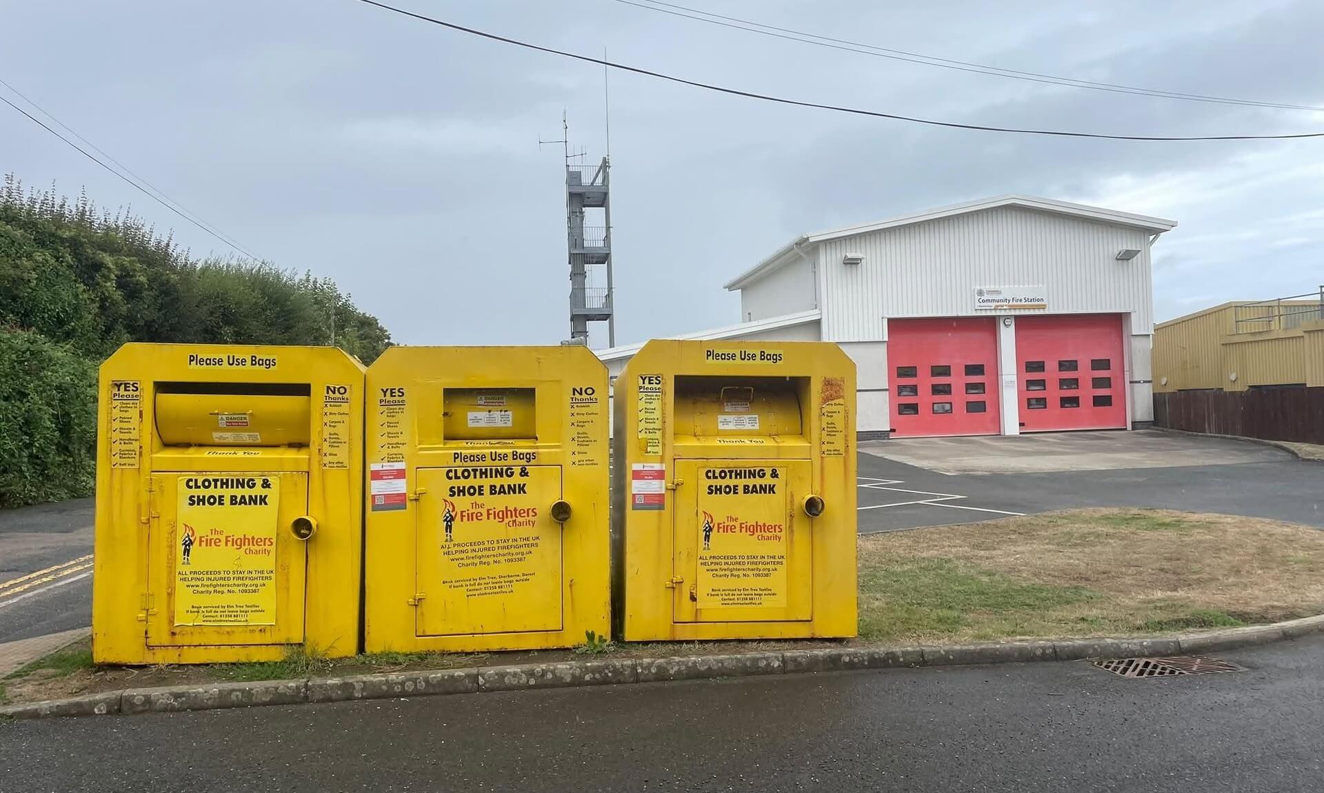Three yellow clothing and shoe banks outside Wadebridge Community Fire Station