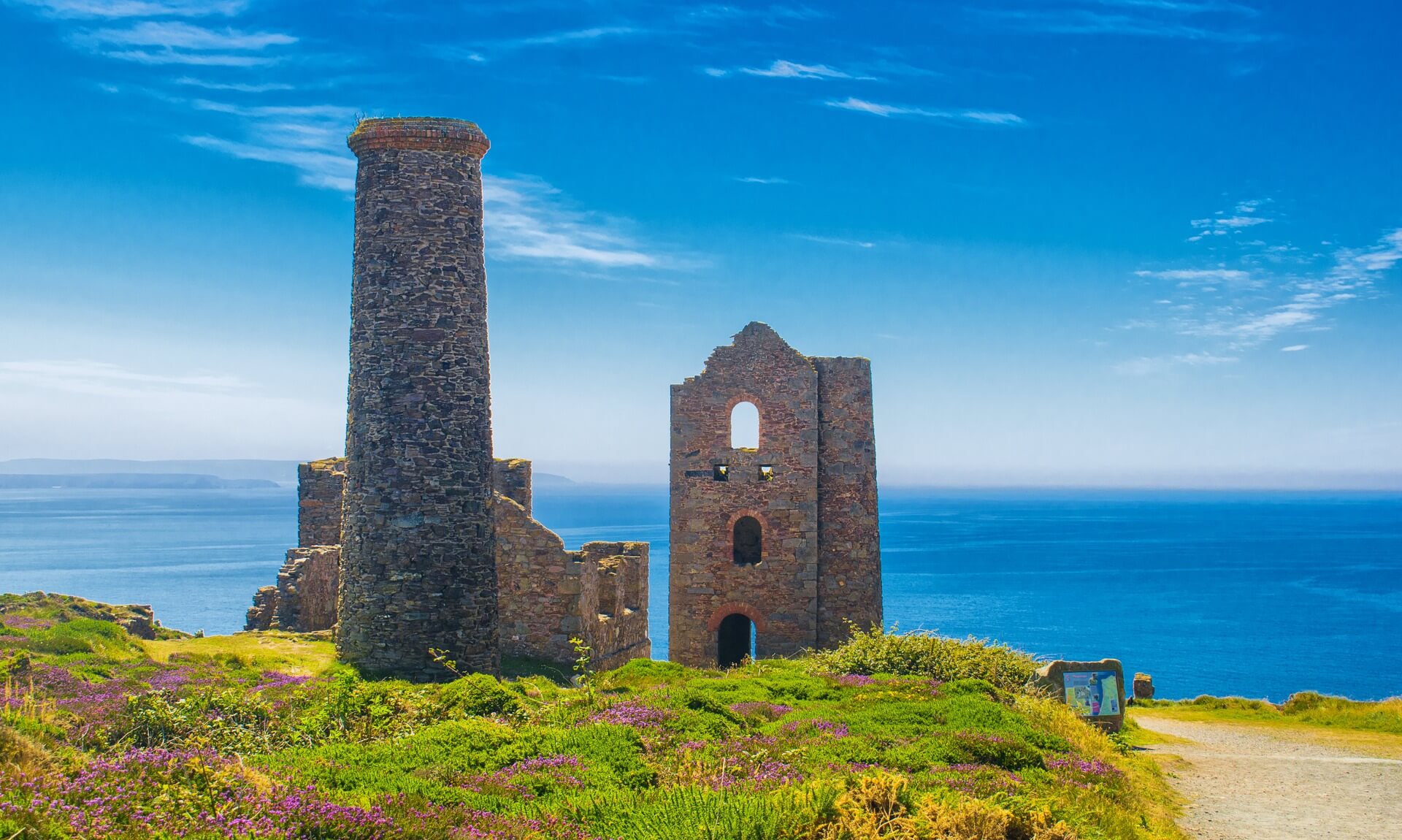 The ruined engine house and chimney of Wheal Coates on the clifftop above the sea near St Agnes, Cornwall