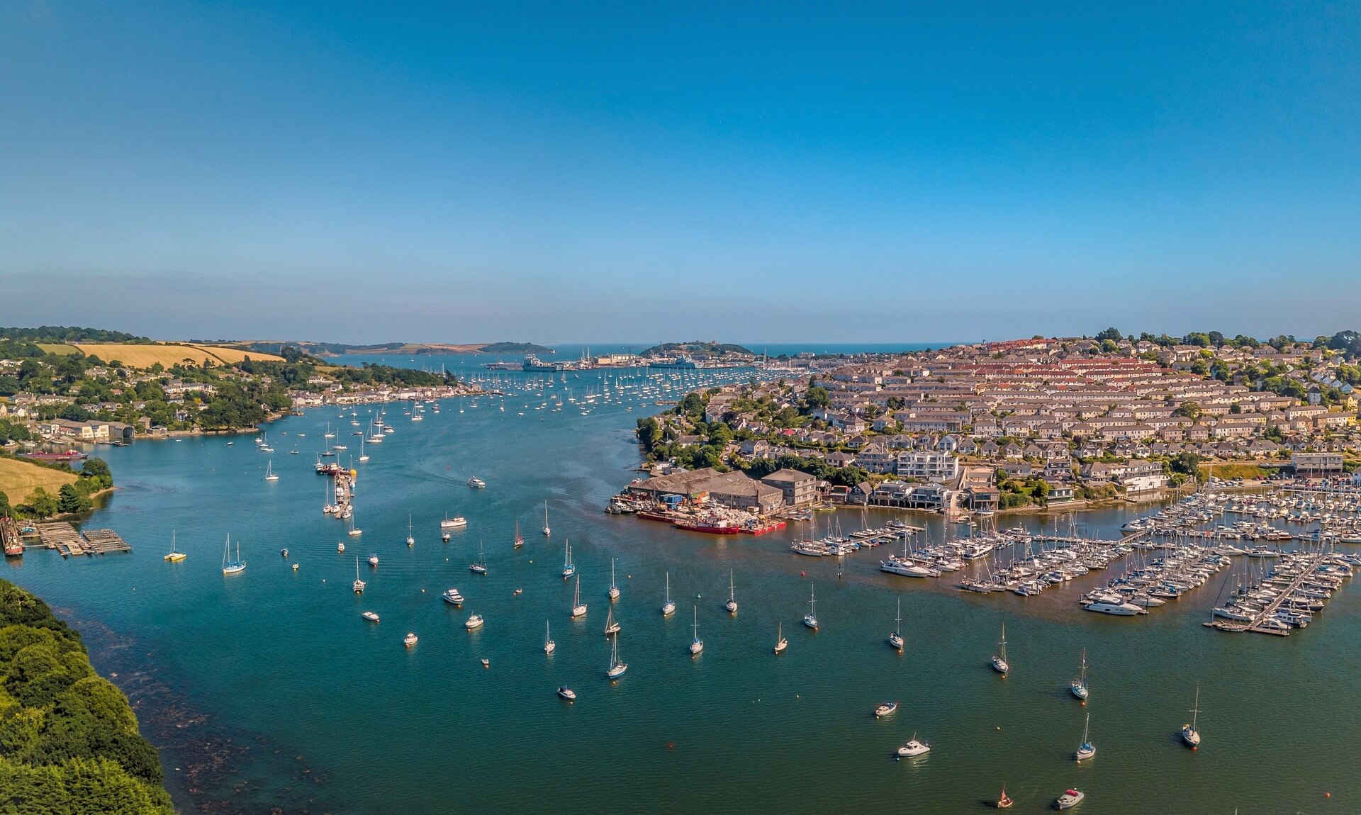 Aerial view of Falmouth harbour and the Penryn river filled with moored boats