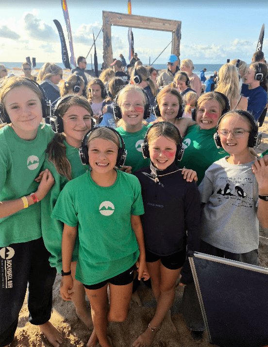 Nippers wearing headphones at a beach silent disco