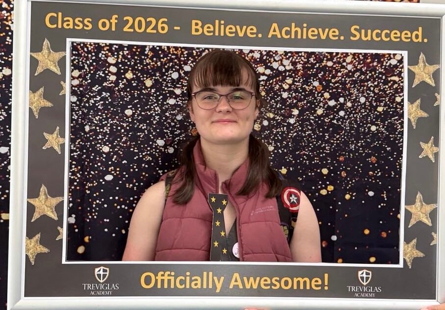 A Treviglas Academy student posing in the Class of 2026 photo frame