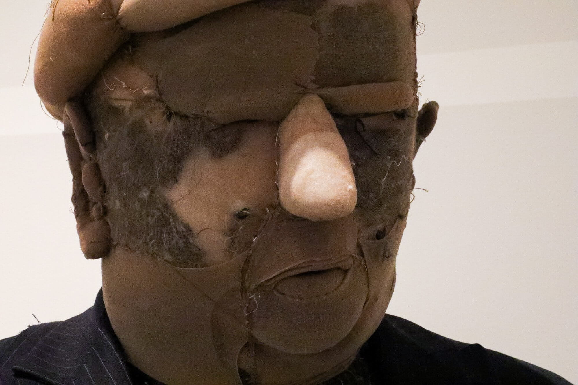 Close-up of the Donald Trump figure's stitched fabric face