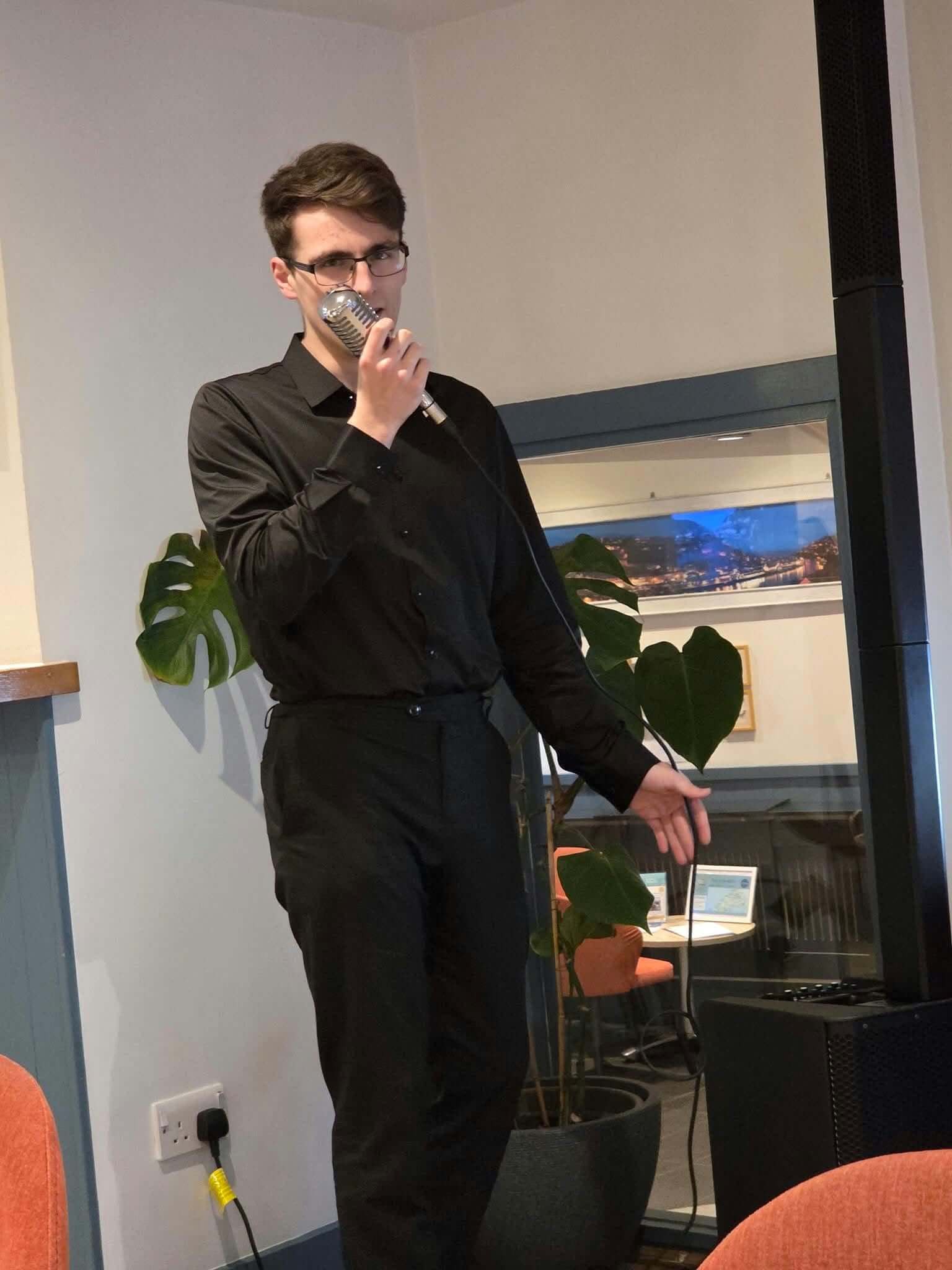 Jacob Reed singing into a vintage microphone